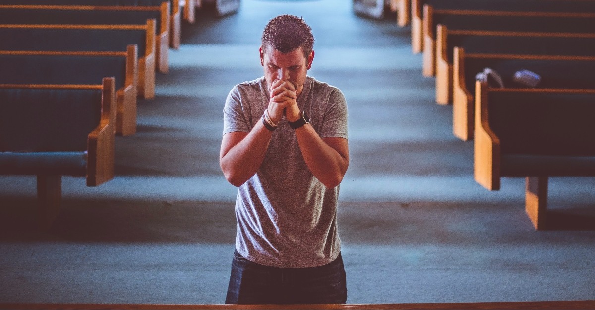 Man kneeling at the altar of a church