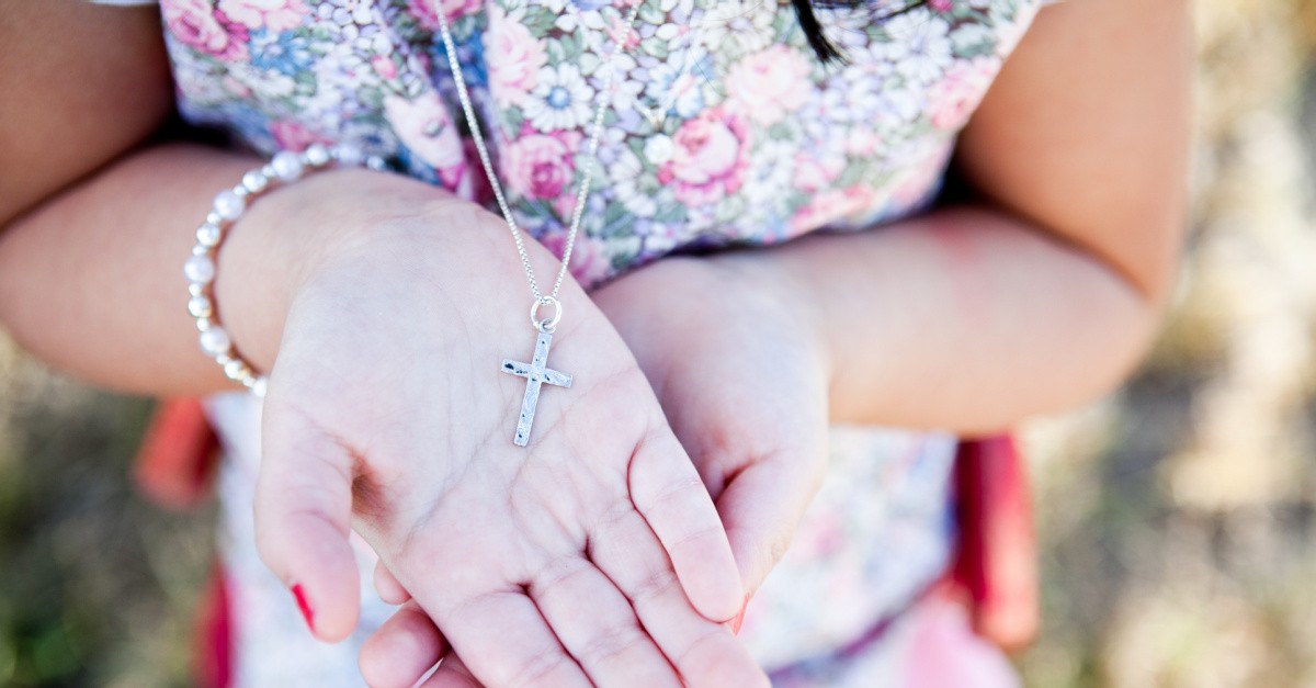 a person wearing a cross necklace, VA governor signs a law protecting outward expressions of faith