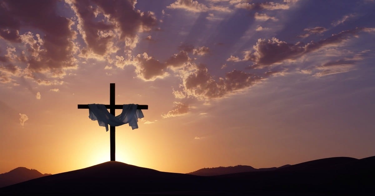 Cross with white fabric at sunset; answering unbelievers' question, 'why did Jesus have to die?'